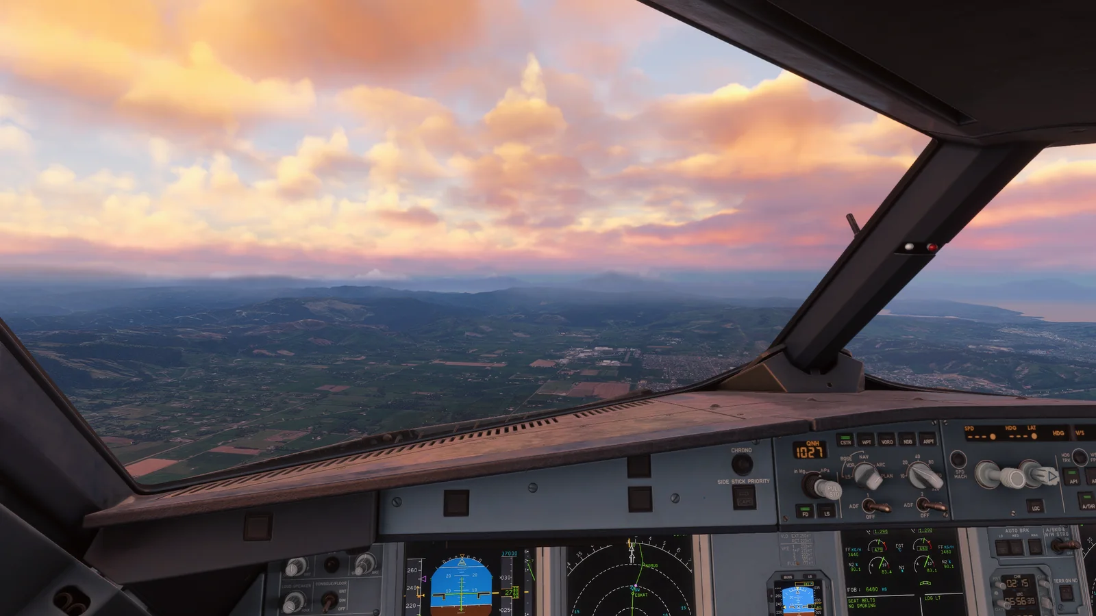 Flight simulator cockpit beneath a colourful sunset